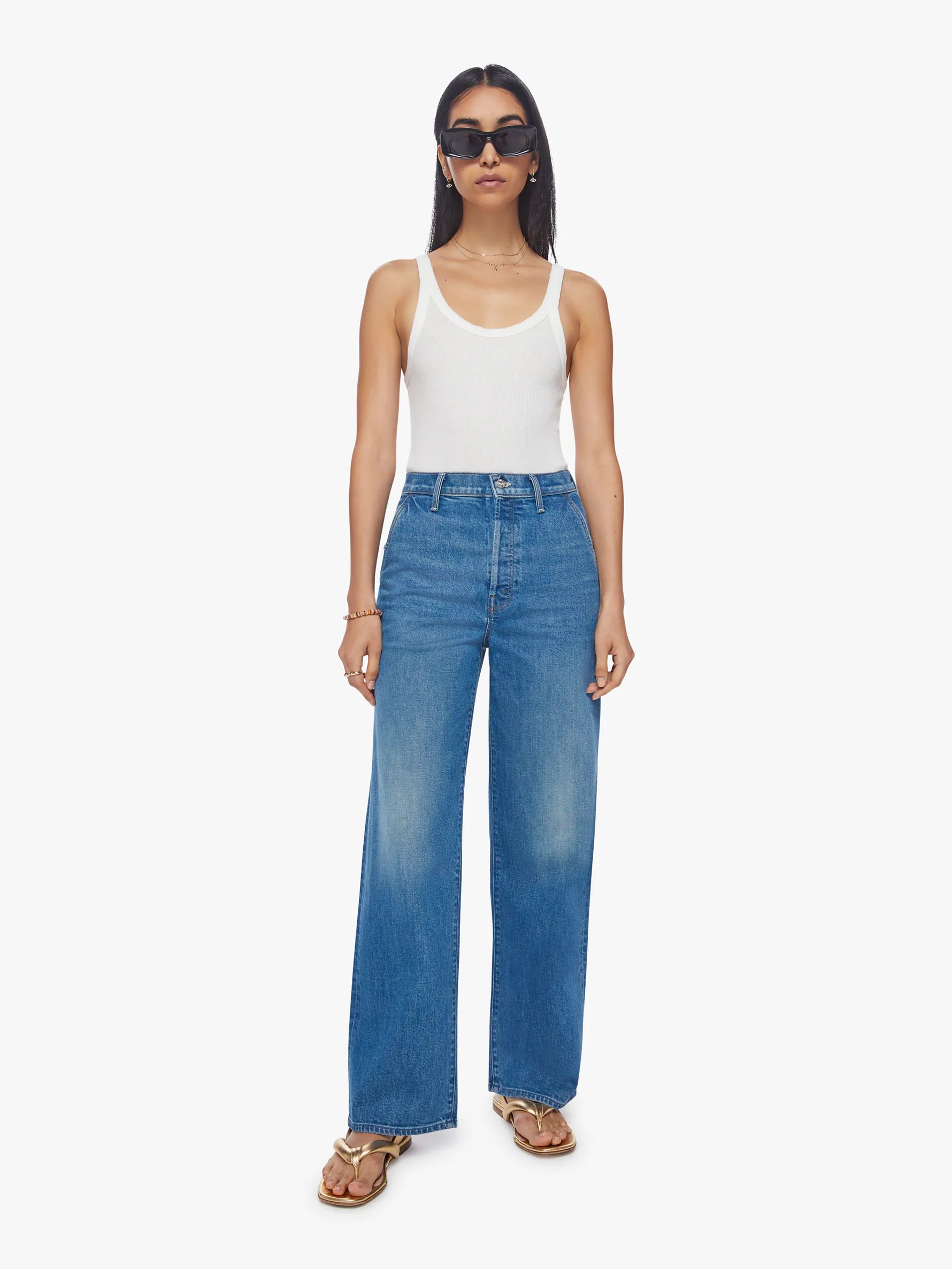 Blast from the past. Super high-rise jeans with a loose wide leg, button fly, slit pockets and a 31-inch inseam with a clean hem. Cut from semi-rigid SUPERIOR denim, Flashback is a mid-blue wash with subtle fading and whiskering.  This style runs small. MOTHER suggests sizing up one size.   These jeans are rigid and take time to break in. MOTHER says patience is a virtue.