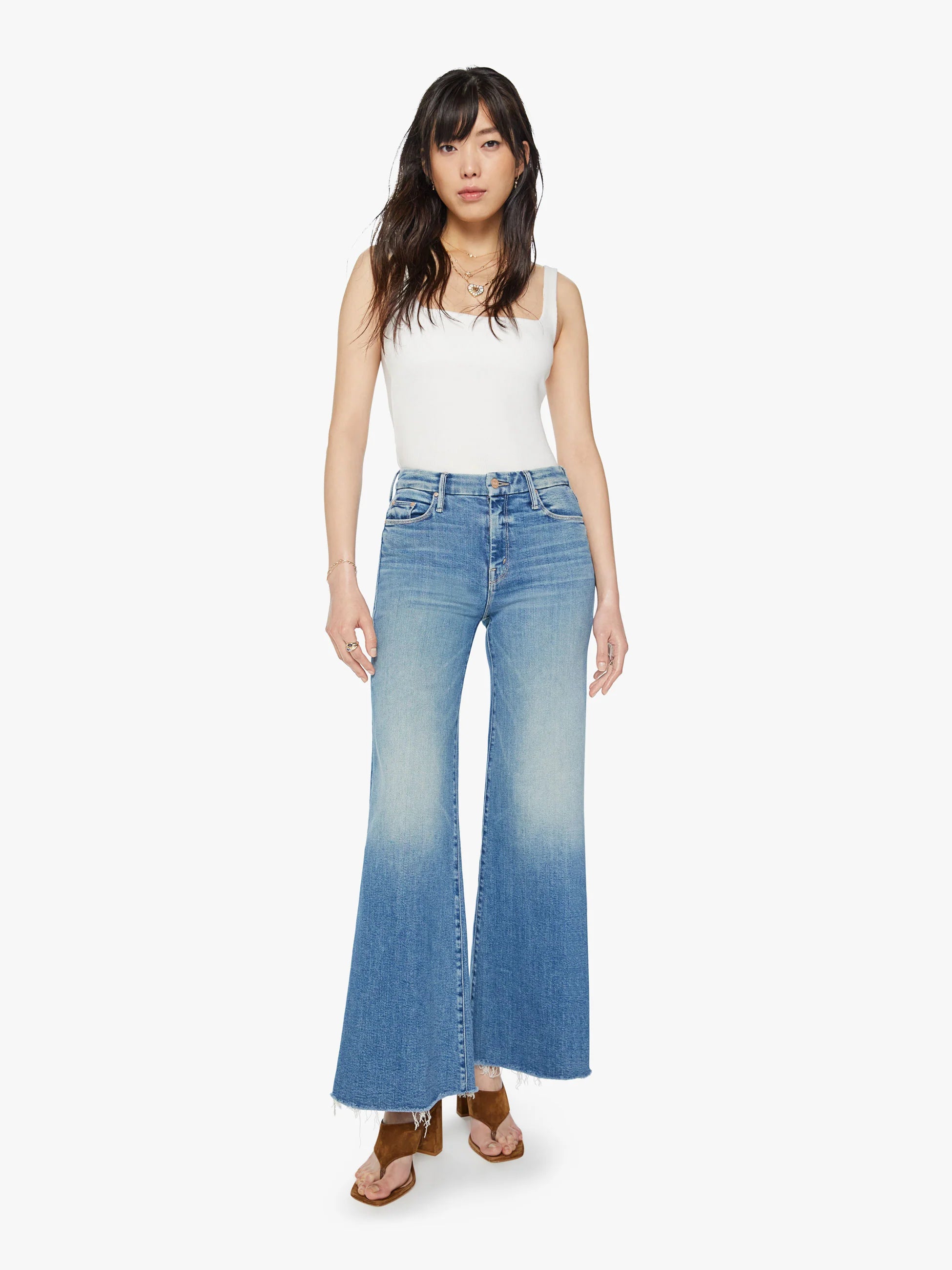 A real cliffhanger. This iconic high-waisted wide leg has a 31-inch inseam and a frayed hem. Cut from stretch denim, Riding The Cliffside is a mid-blue wash with whiskering and fading.  10" Rise 31" Inseam 26" Leg Opening  Model is 5' 10" wears size 26 or small bottoms and size small shirts.  78% Cotton 16% Modal 4% Polyester 2% Elastane