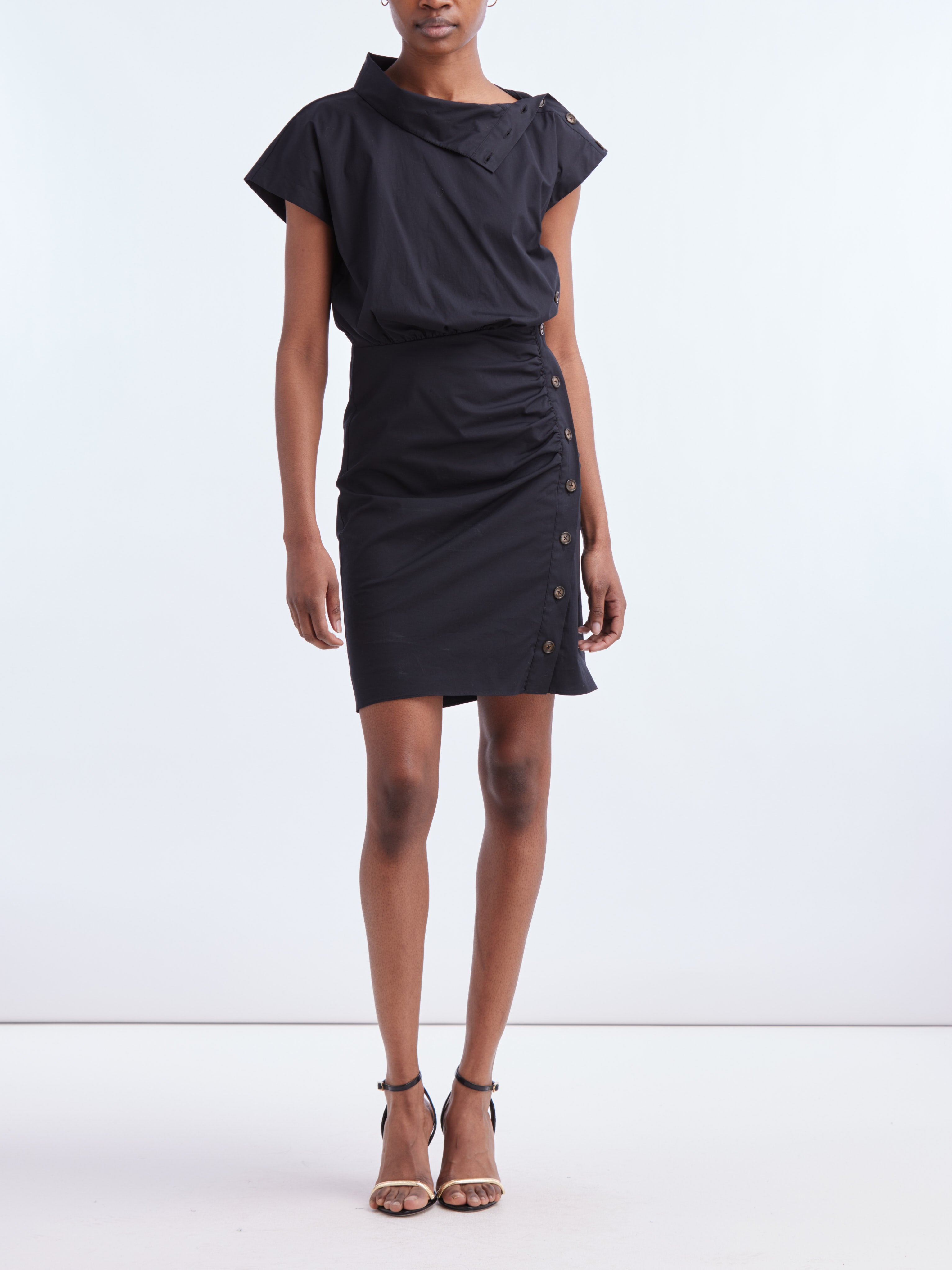 A feminine reimagination of the classic shirtdress. With its asymmetrical collar and cap sleeves, this crisp poplin style is completed with tortoise buttons along the shoulder and down the side. Our signature ruching is beautifully at play here, creating a figure-flattering silhouette that makes it an easy go-to for everyday wear. Dress it up with boots for nights out.