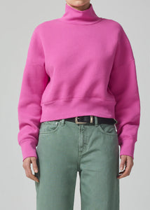 This turtleneck sweatshirt has an relaxed feel and slightly cropped fit. Pair yours with utility or denim.  This fit is true to size.  Wash:  Looks Like: Rouge pink long sleeve turtleneck Feels Like: Midweight breathable cotton that is smooth and cool to the hand