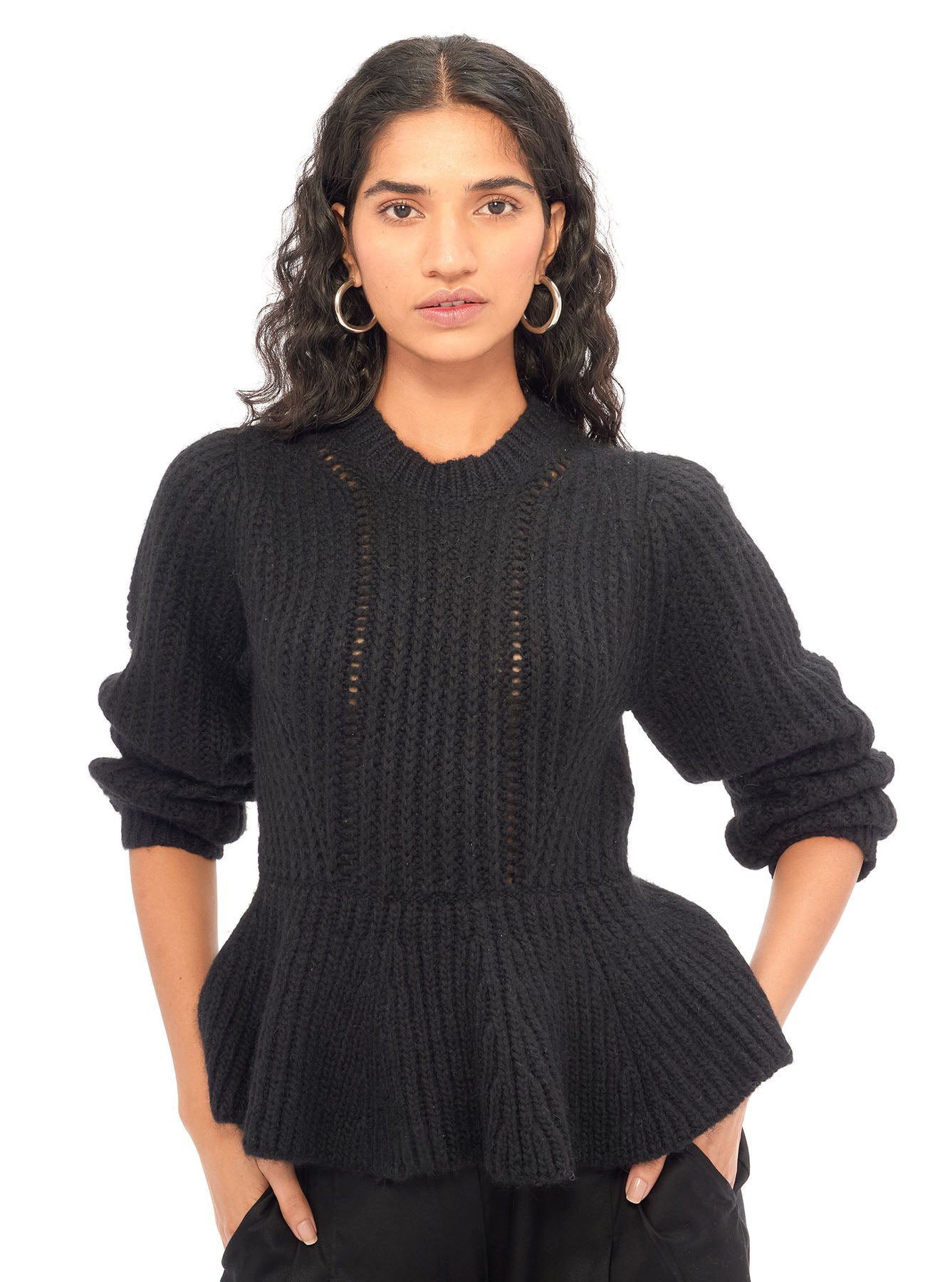 A stunning, incredibly soft hand knit baby alpaca sweater in rich black. This is cozy, yet dressy with the slight peplum style and beautiful knit details.
