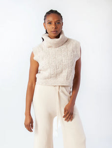 Sleeveless turtleneck top in floral cable relief pattern.  5% WOOL 92% RECYCLED POLY 3% ELASTANE  #M6039