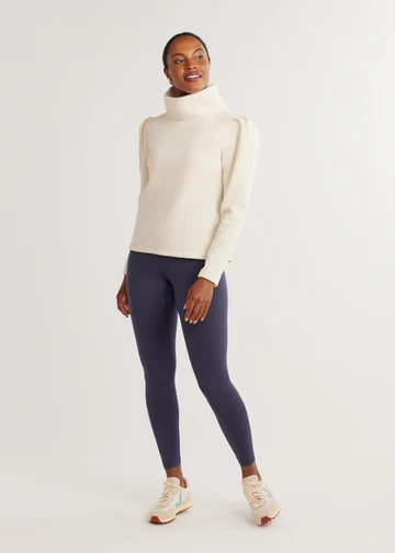 Our flagship silhouette gets a touch of feminine whimsy. Consider the puff sleeve on this newly imagined take on the turtleneck your styling shortcut to stand out from the crowd.