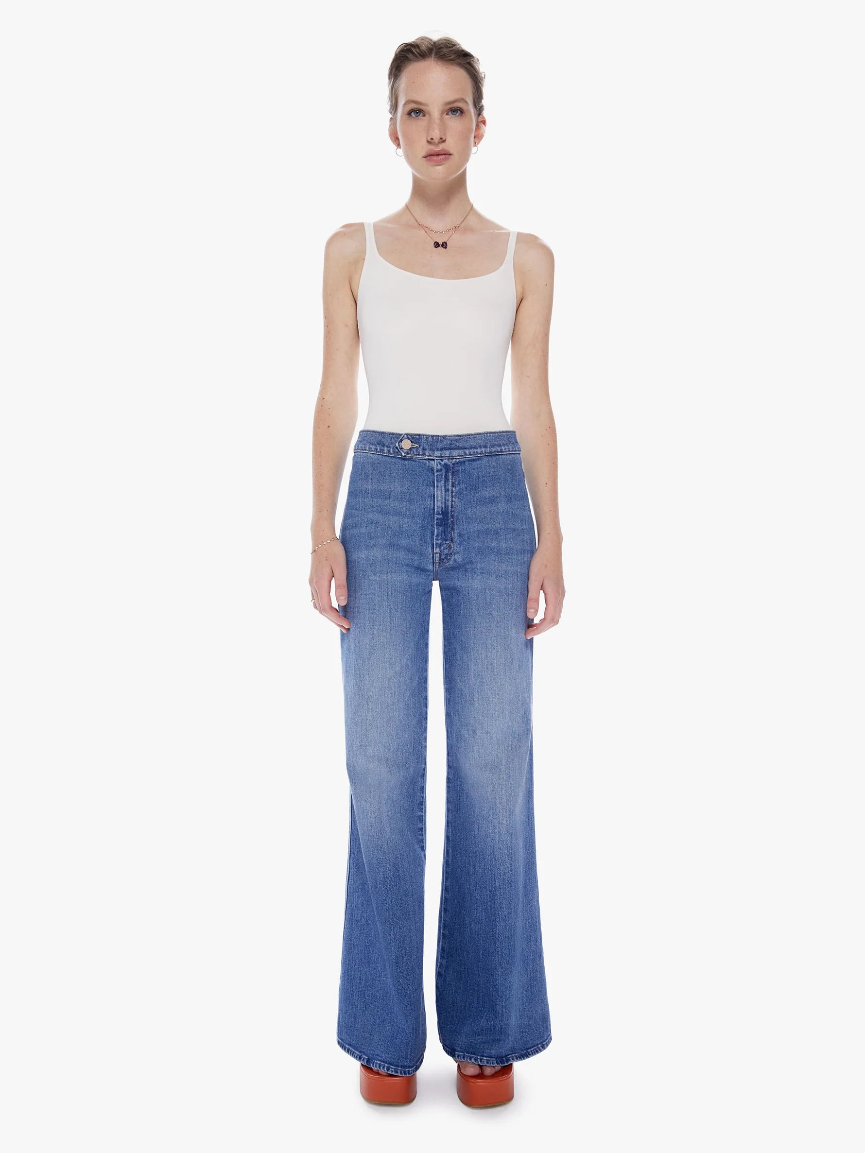 Must be new here. 70s-inspired wide-leg jeans with a high rise, long inseam, waistband tab and a clean hem. Cut from denim with a touch of stretch, From Out Of Town is a mid-blue wash with subtle fading and whiskering.  10 1/2" Rise 31" Inseam 27" Leg Opening